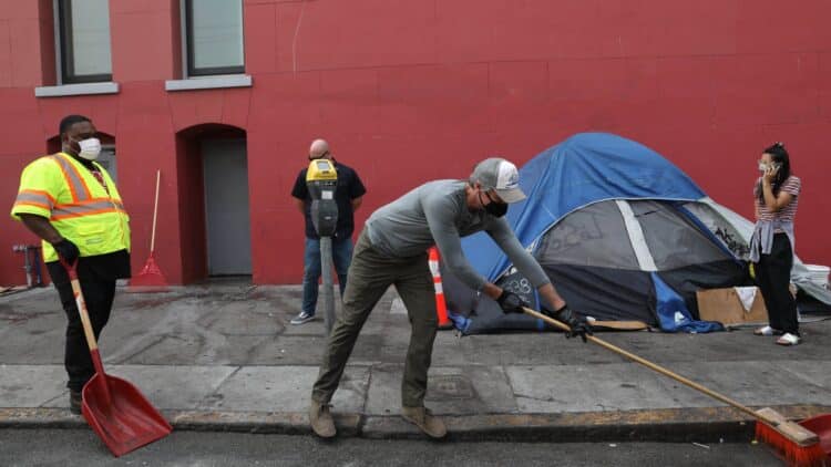 California’s Newsom Stages Photo Op Cleaning Up Homeless
Camp Before Recall 1