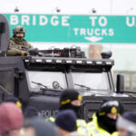 US Truckers Gather Under Border Bridge in Michigan Without
Causing Blockade 7